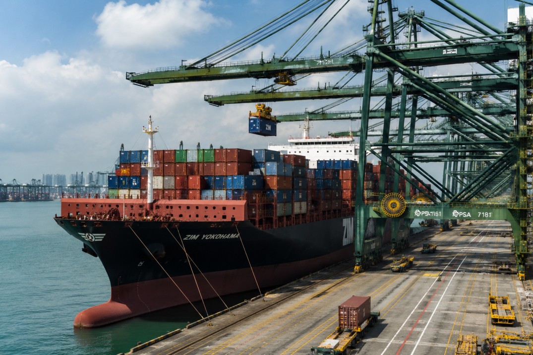 Container ship loading operations at Singapore maritime port terminal